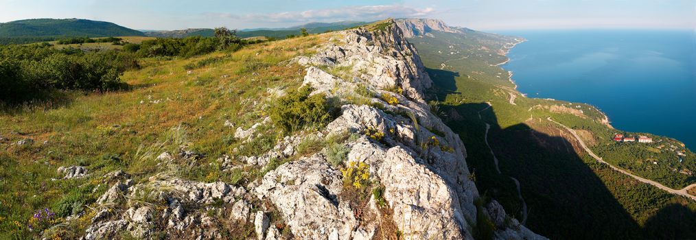 View from the top of the mountain to the steep. Wide-angle panorama.