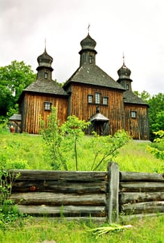 Wooden church with the wooden fence. Kiev, Ukraine.