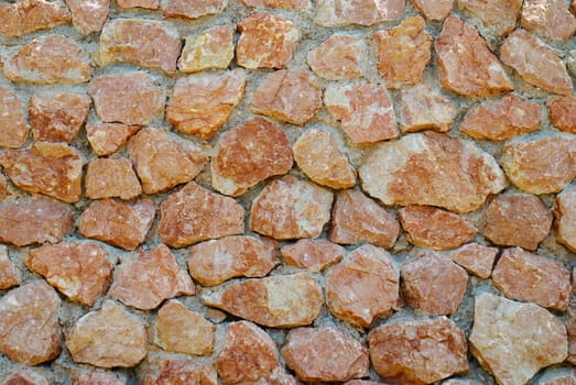 A wall of textured red stones.