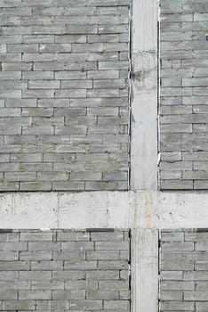 A wall of textured gray construction bricks.