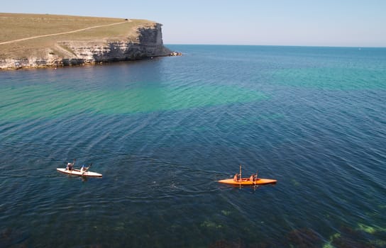 Kayakers sculling on the sea.