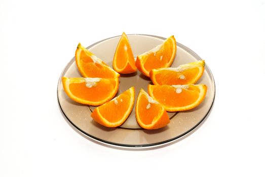 Orange segments on the plate isolated on white.