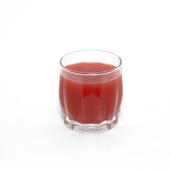 Juice in glass isolated on white.