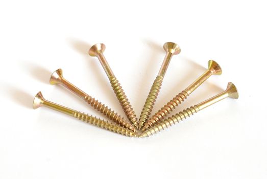 Golden screws on white background.