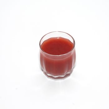 Juice in glass isolated on white.