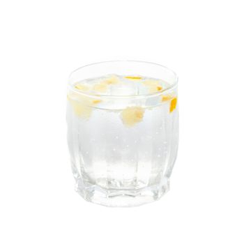 A cold water glass with lemon isolated on white.