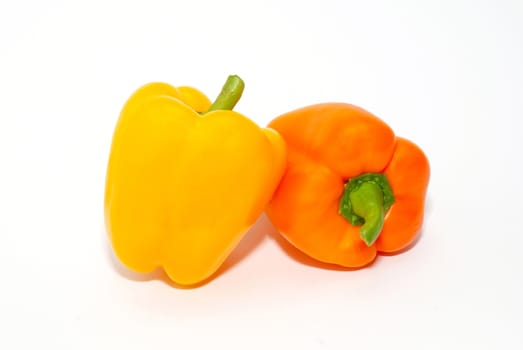 Orange and yellow paprika isolated on white.