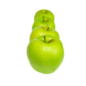 Row of green apples isolated on white.