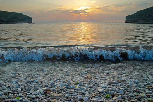 Sunset on the sea with the waves.