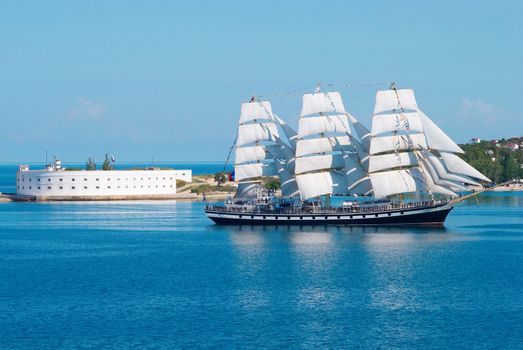 Sailing ship entering to the bay.