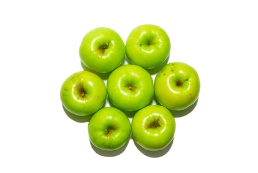 Stack of green apples isolated on white.