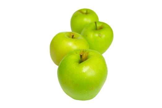 Row of green apples isolated on white.