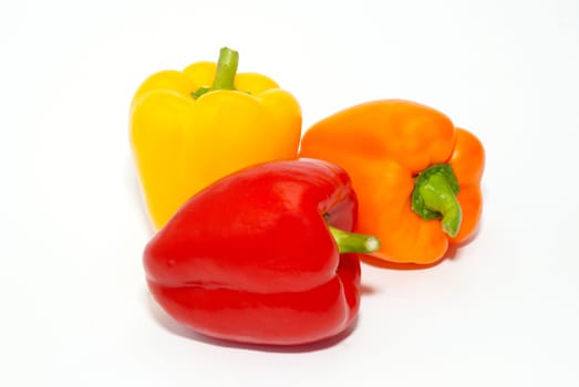 Three colored paprika isolated on white.