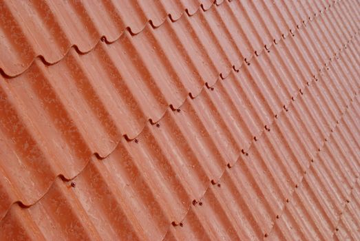 Wall of textured red tile.