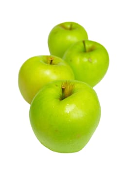 Row of green apples isolated on white.