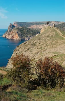 Sea landscape with rocks and tower.