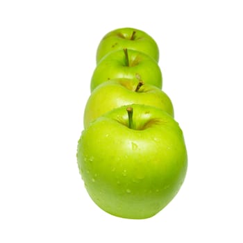 Row of green apples isolated on white.