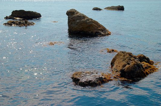 Sea landscape with rocks and water surface.