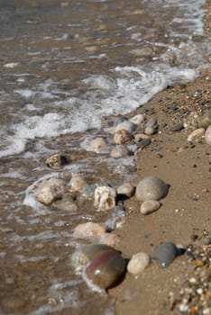 Rocks in the waves and sea foam.