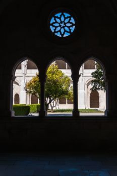Courtyard of Portuguese Alcobaca Monastery seen through a window