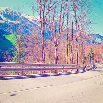 Asphalt Road on the Background of Snow-capped Alps in Switzerland, Instagram Effect