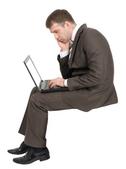 Sad businessman working on laptop isolated on white background