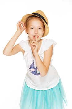 Little girl posing for the camera in a brown hat