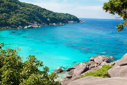 Thailand Similan Islands landscape with bright blue water, rocks and green plants