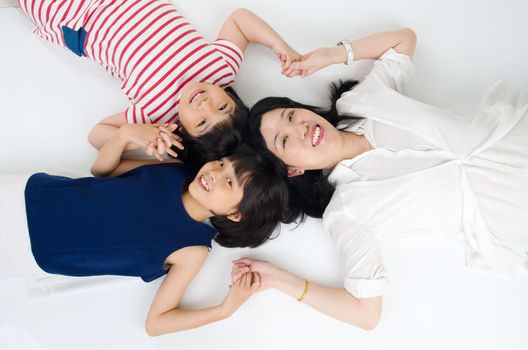 Lovely asian family lying on the floor