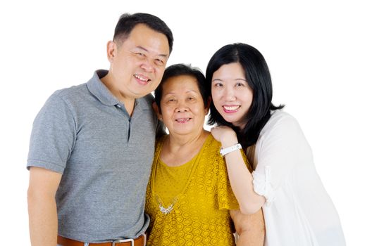 Senior woman with her daughter and son. Happy Asian family mother and adult offspring indoor portrait.