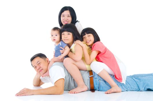 Asian family having piggyback fun