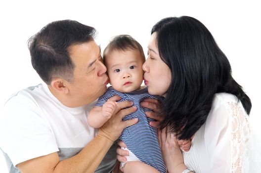 asian parent kissing their baby boy