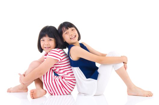 Asian sisters sitting on the floor