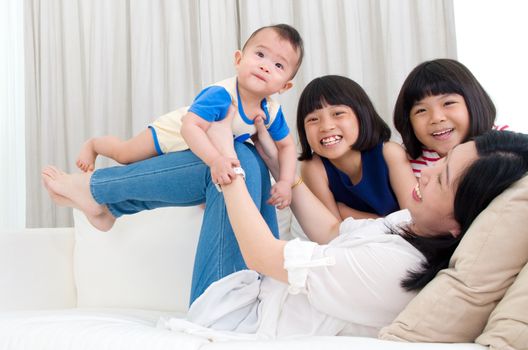 Asian mother playing with her children 