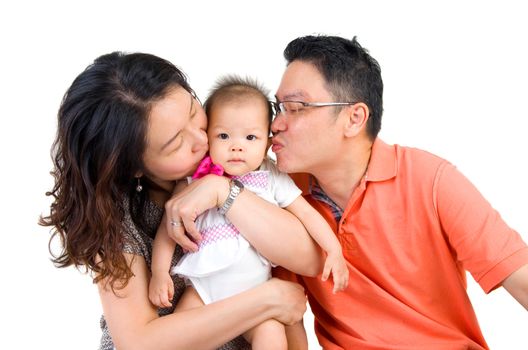 asian parent kissing their baby girl