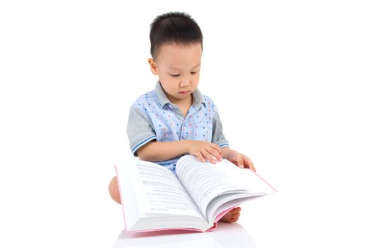 Asian boy sitting on the floor and reading