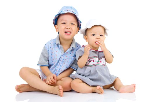 Asian brother and sister sitting on the floor 