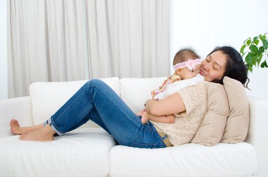 Asian mother playing with her baby