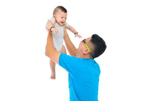 Asian father lifting up her baby