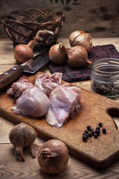 raw fillet of chicken meat and onions in the process of cooking food