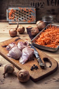 raw fillet of chicken meat and onions in the process of cooking food