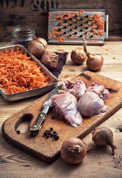 raw fillet of chicken meat and onions in the process of cooking food