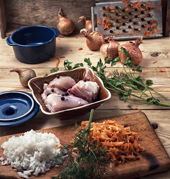 raw fillet of chicken meat and onions in the process of cooking food