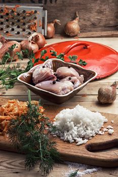 raw fillet of chicken meat and onions in the process of cooking food