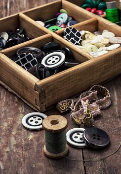 tools seamstresses on wooden background.the image is tinted in vintage style