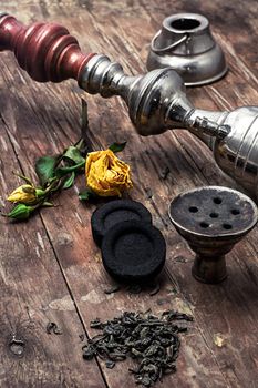 details Shisha and accessories on wooden background.image is tinted in vintage style