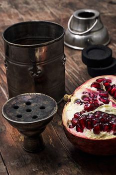 details Shisha and accessories on wooden background.image is tinted in vintage style