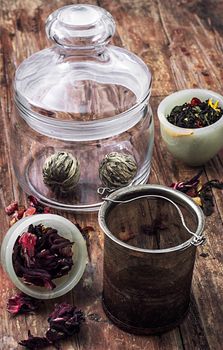 different varieties of brewed leaf tea in glass jar. The image is tinted in vintage style