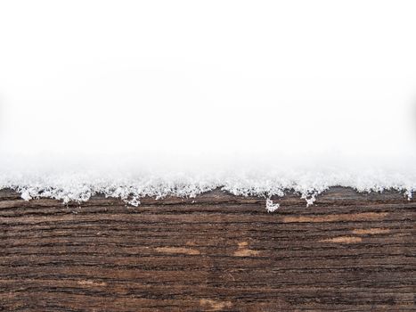 Detail of weathered painted wooden bench covered in snow, top of timber, plank or board with white copyspace on the top, winter time illustration or background