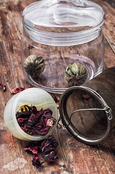 different varieties of brewed leaf tea in glass jar. The image is tinted in vintage style